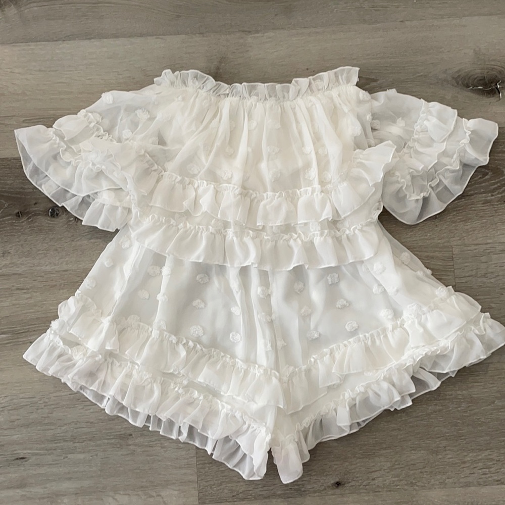 White feminine strapless romper with ruffles